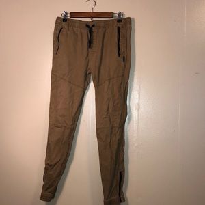 khaki joggers with black zippers